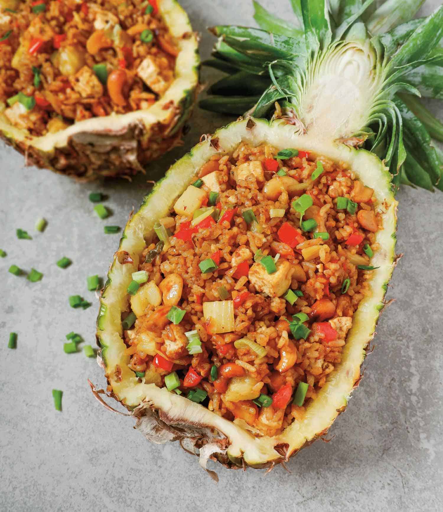 Thai vegan pineapple fried rice recipe served in an open hollowed half pineapple