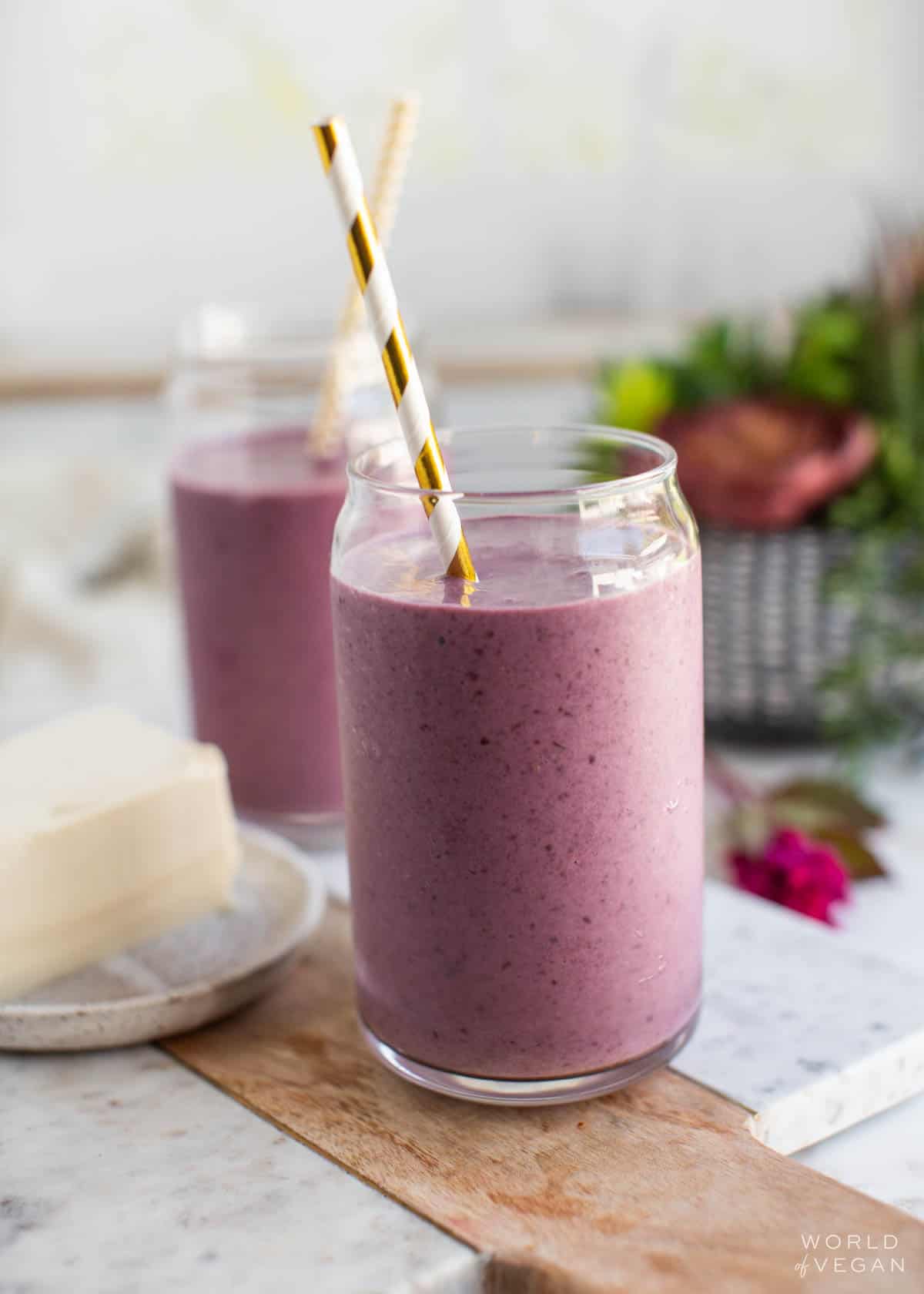 Cherry silken tofu smoothies in glasses next to a block of silken tofu.