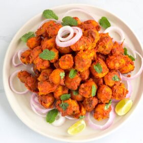 A plate of vegan fried appetizer.