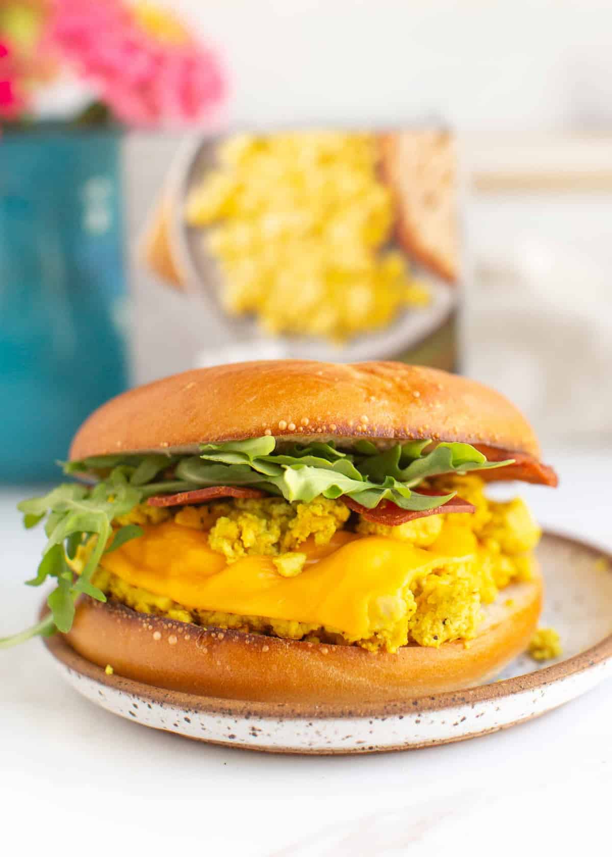 A vegan breakfast sandwich with arugula.