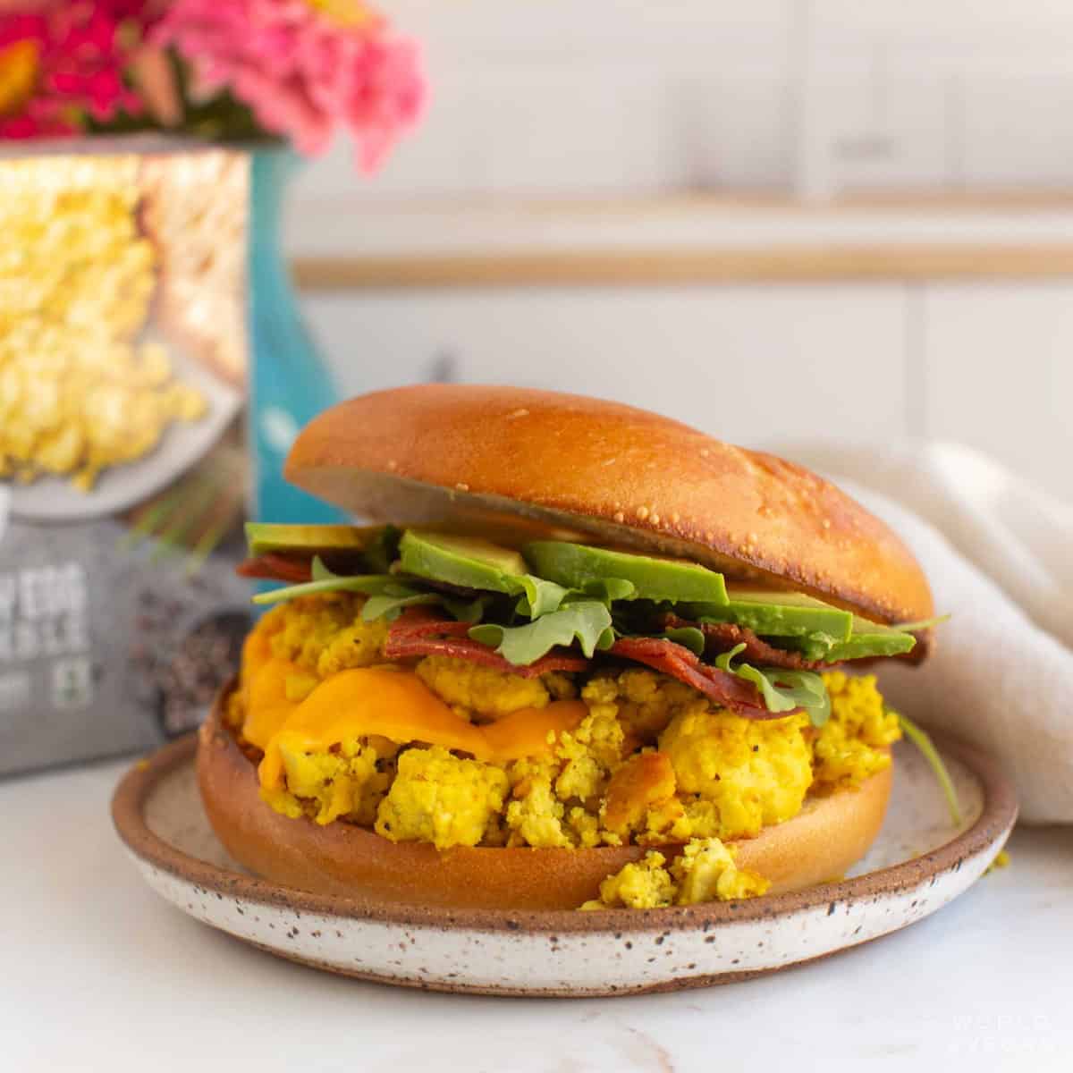 A vegan breakfast sandwich with avocado.