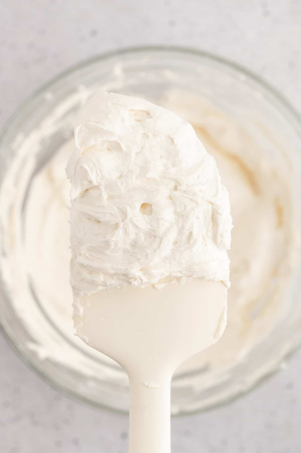 Vegan buttercream frosting on a spatula.