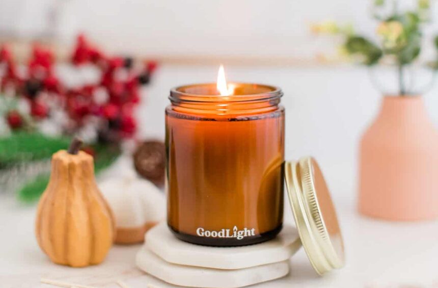 fall vegan candle in jar with pumpkin and holiday decor