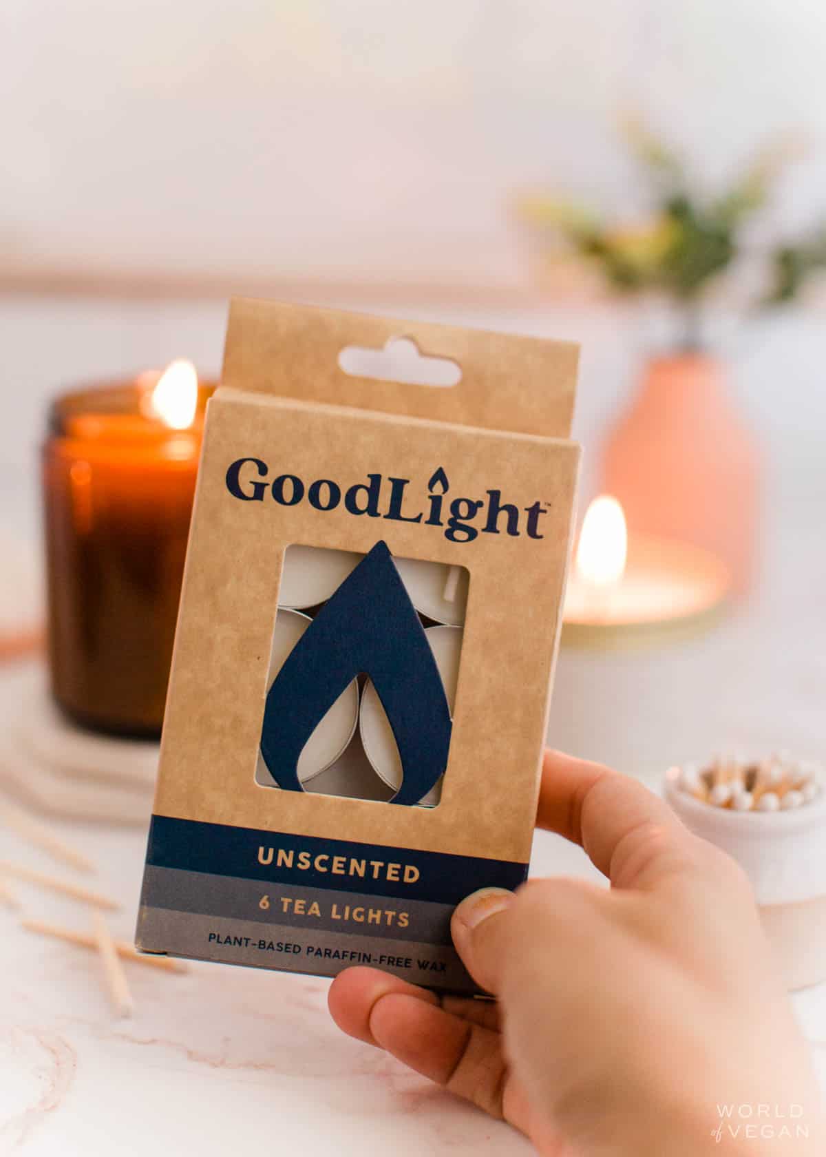 hand holding a box of plant based tea light candles from the brand GoodLight