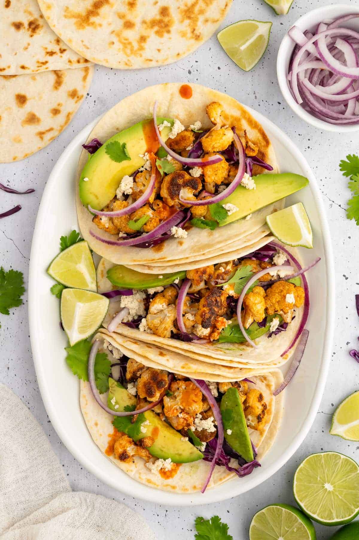 A plate with three vegan cauliflower tacos.