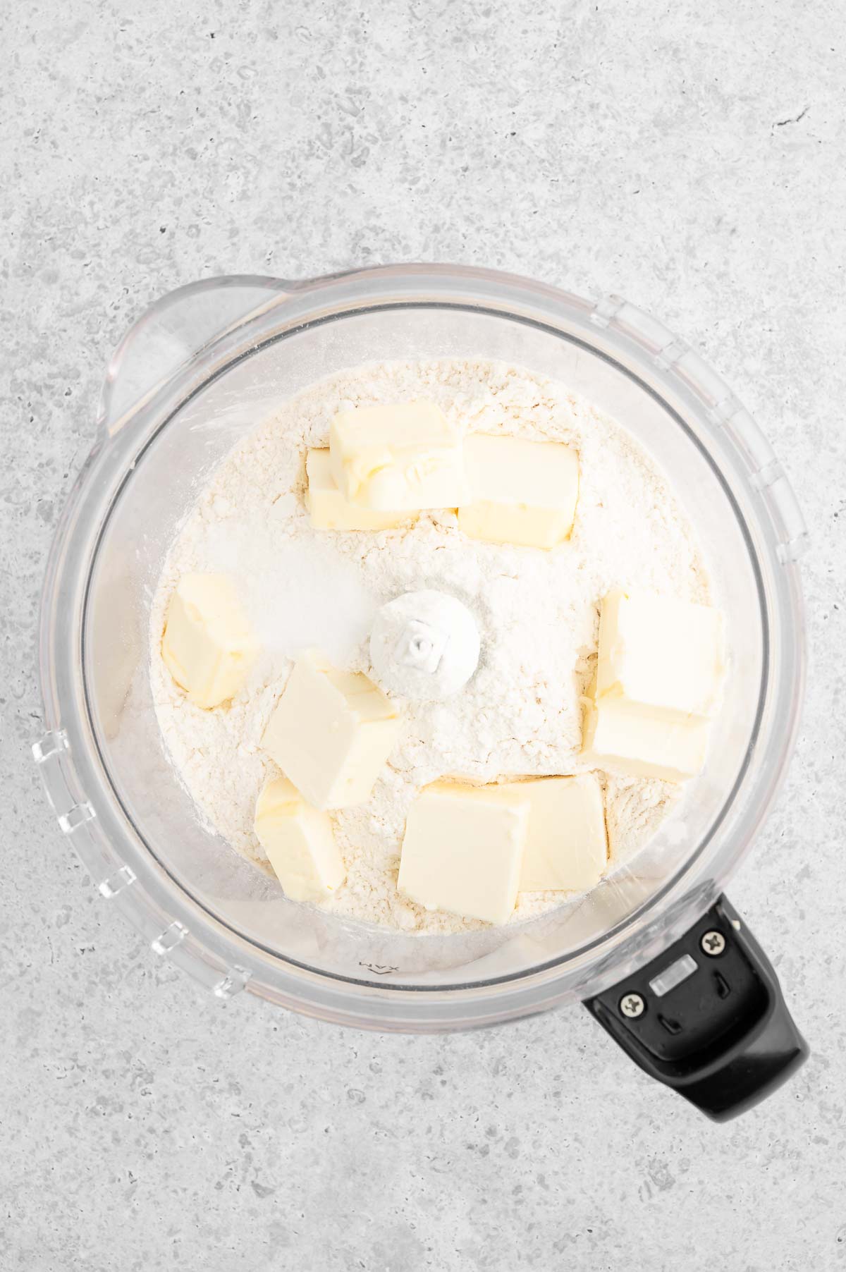 Flour and cubed vegan butter in a food processor to make the crust.