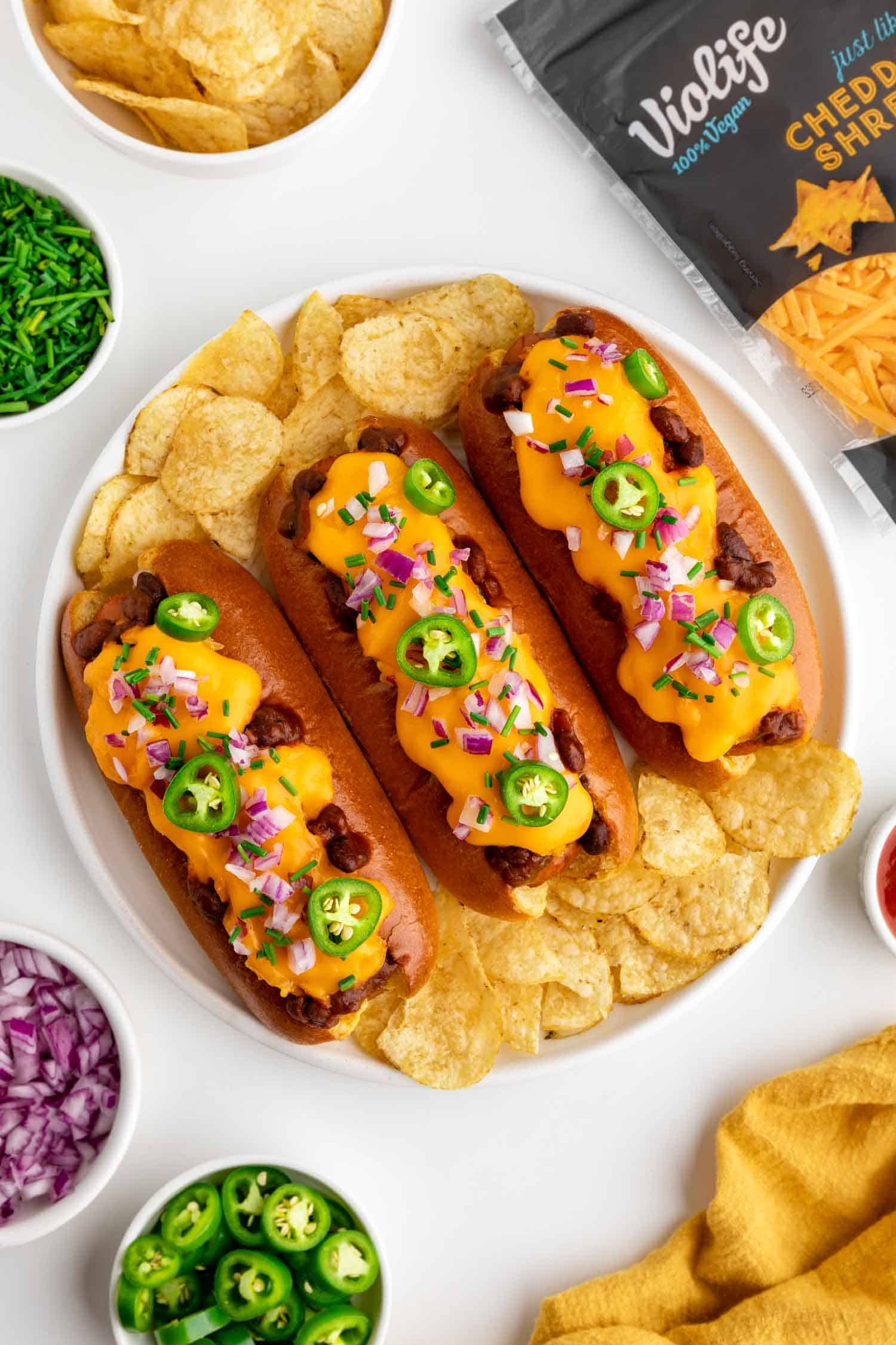 chili cheese dogs ingredient flatlay with violife dairy-free cheddar cheese shreds