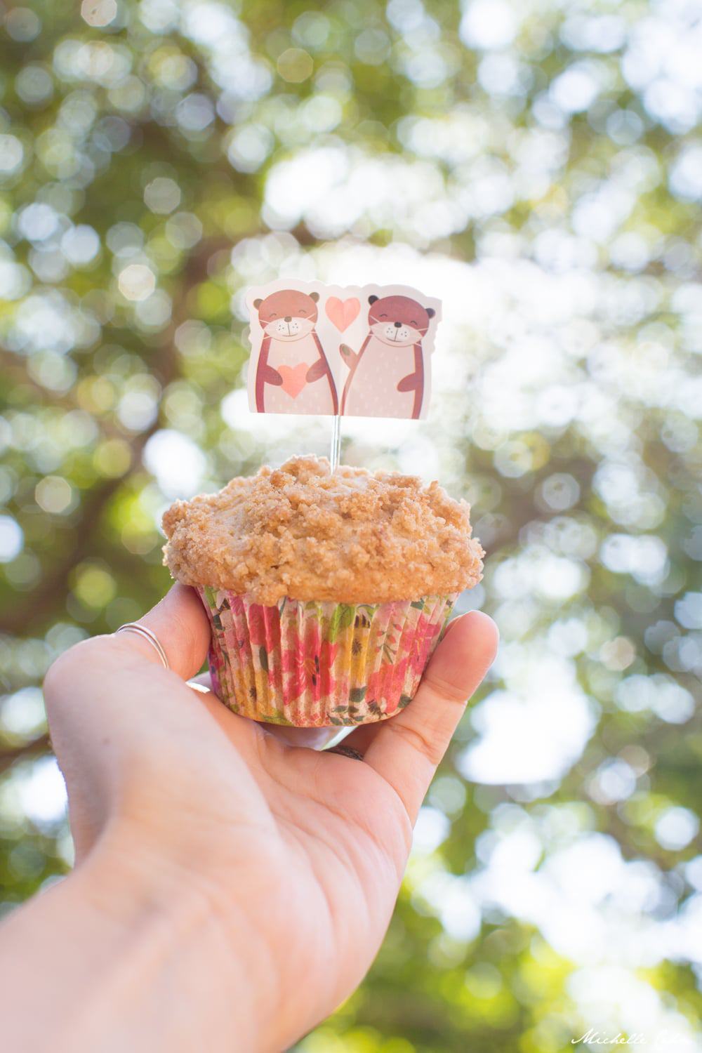 Hand holding a vegan banana muffin.