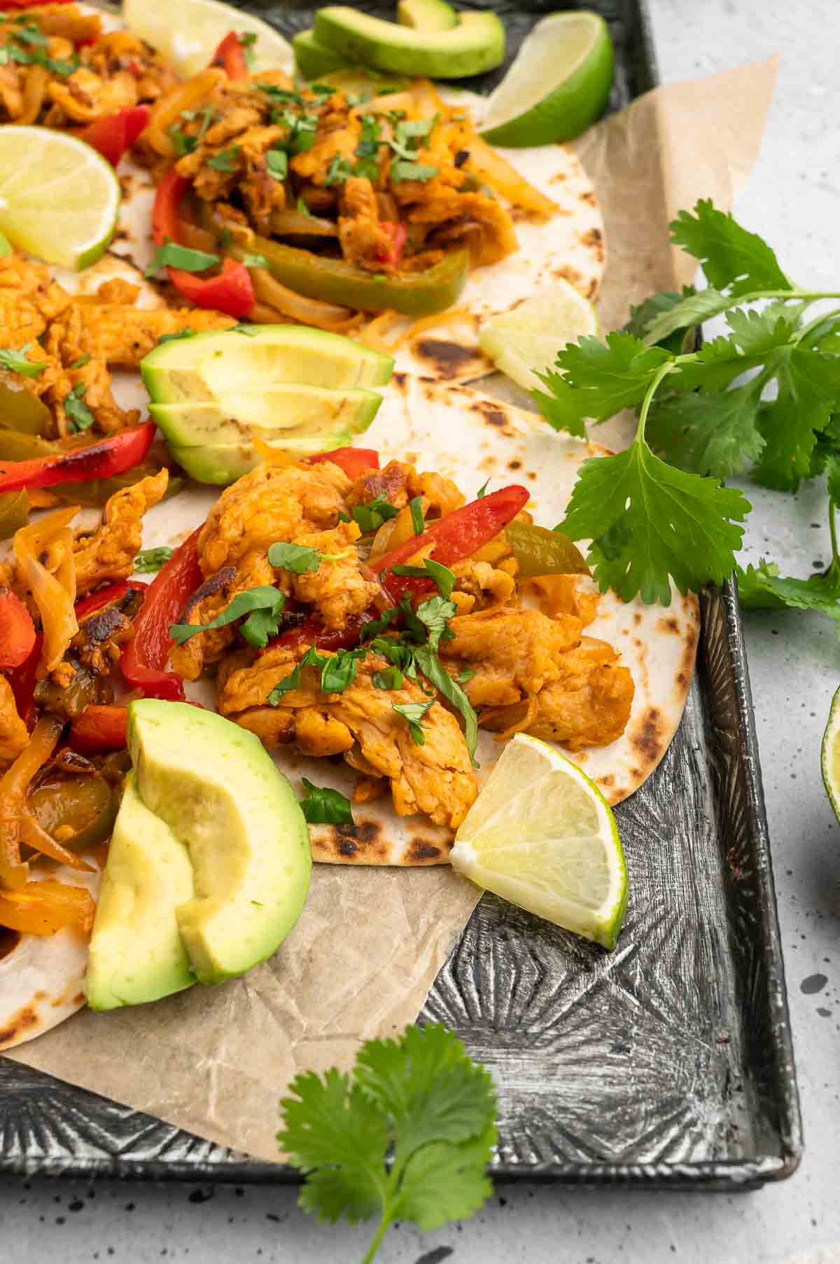 A sheet pan with garnished vegan fajitas.