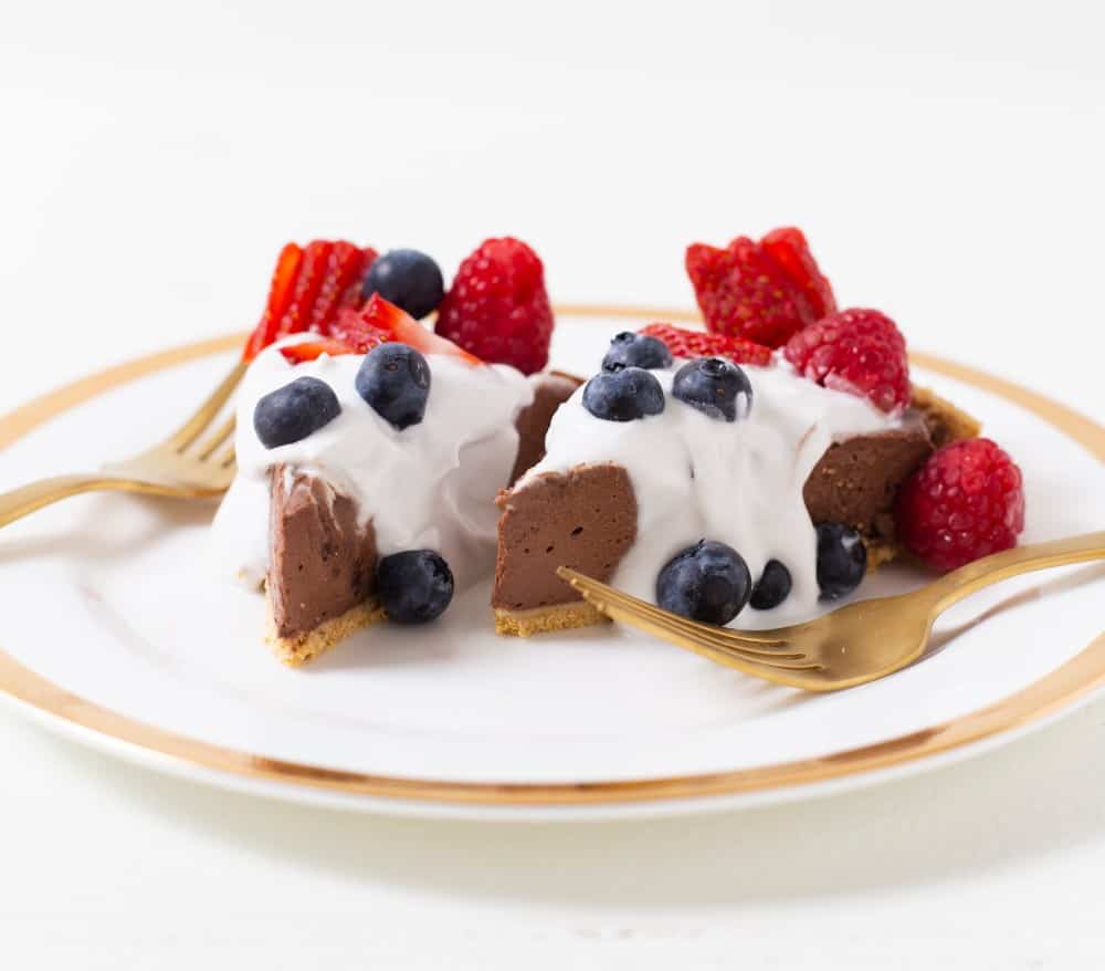 vegan chocolate pie with whipped cream and berries