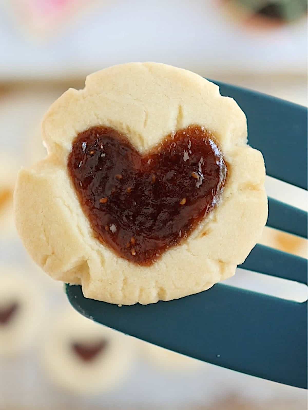 A spatula holding one vegan thumbprint cookie.