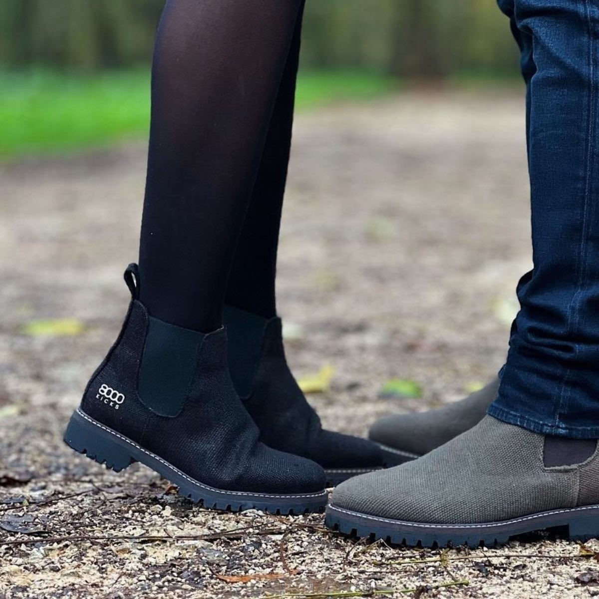 A man and a woman wearing vegan chelsea boots from 8000 kicks in black and grey. 