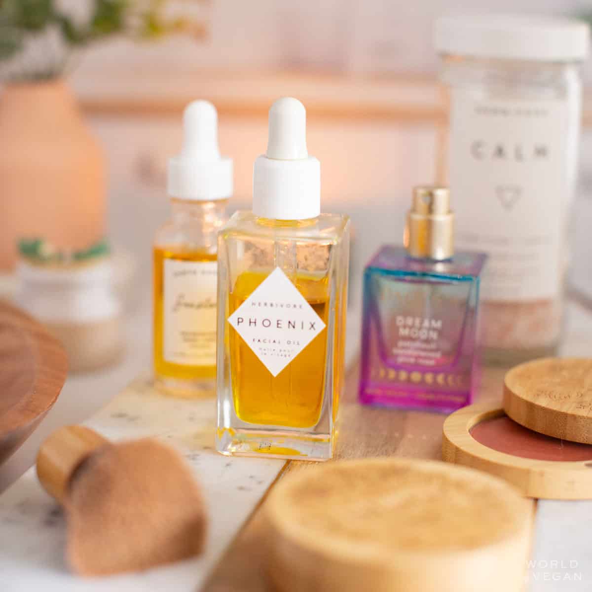 Vegan skincare, makeup, and cruelty-free beauty products on a table with Herbivore facial oil, Pacifica perfume, and more.