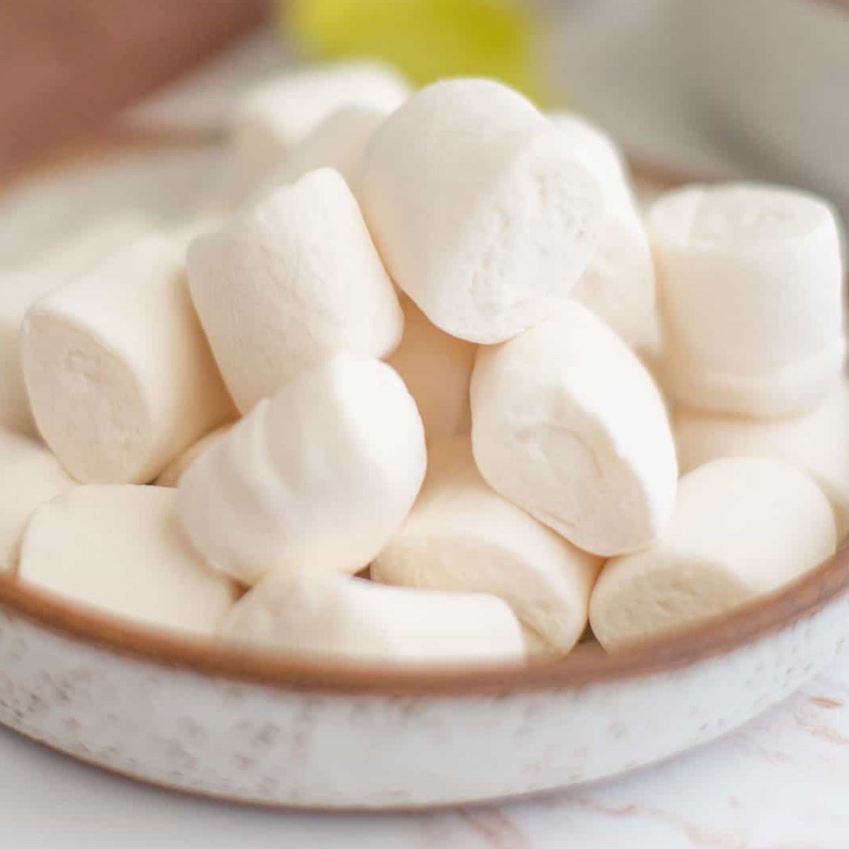 Vegan marshmallows piled on a plate.
