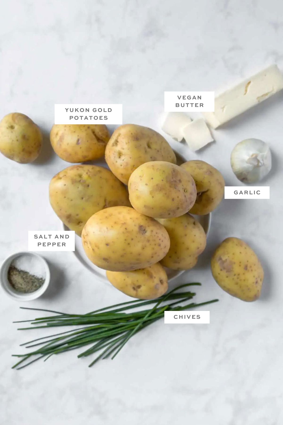 Key ingredients for vegan mashed potatoes with labels.