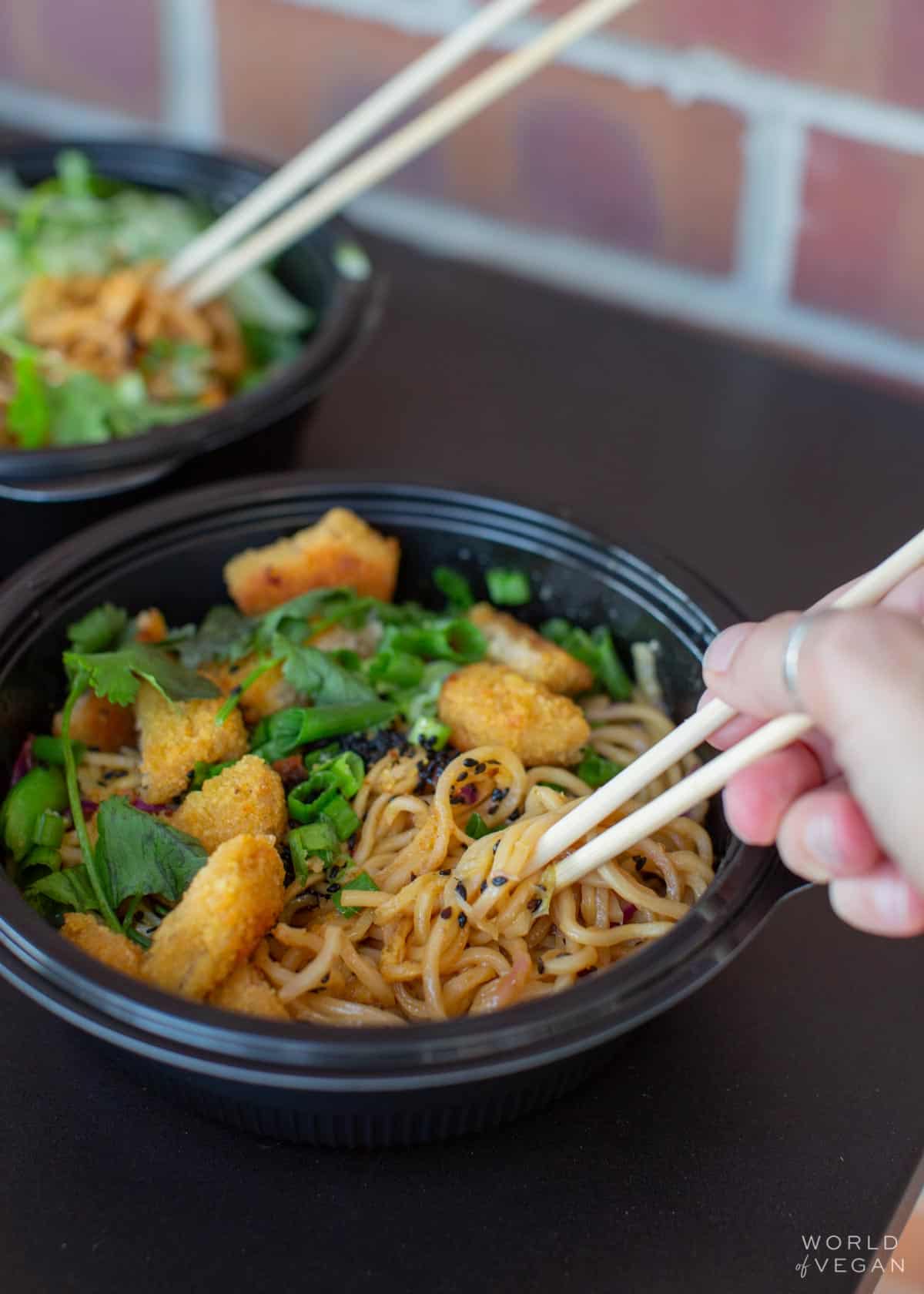 Take Out container of Spicy Korean Beef Noodles made vegan at Noodles and Company