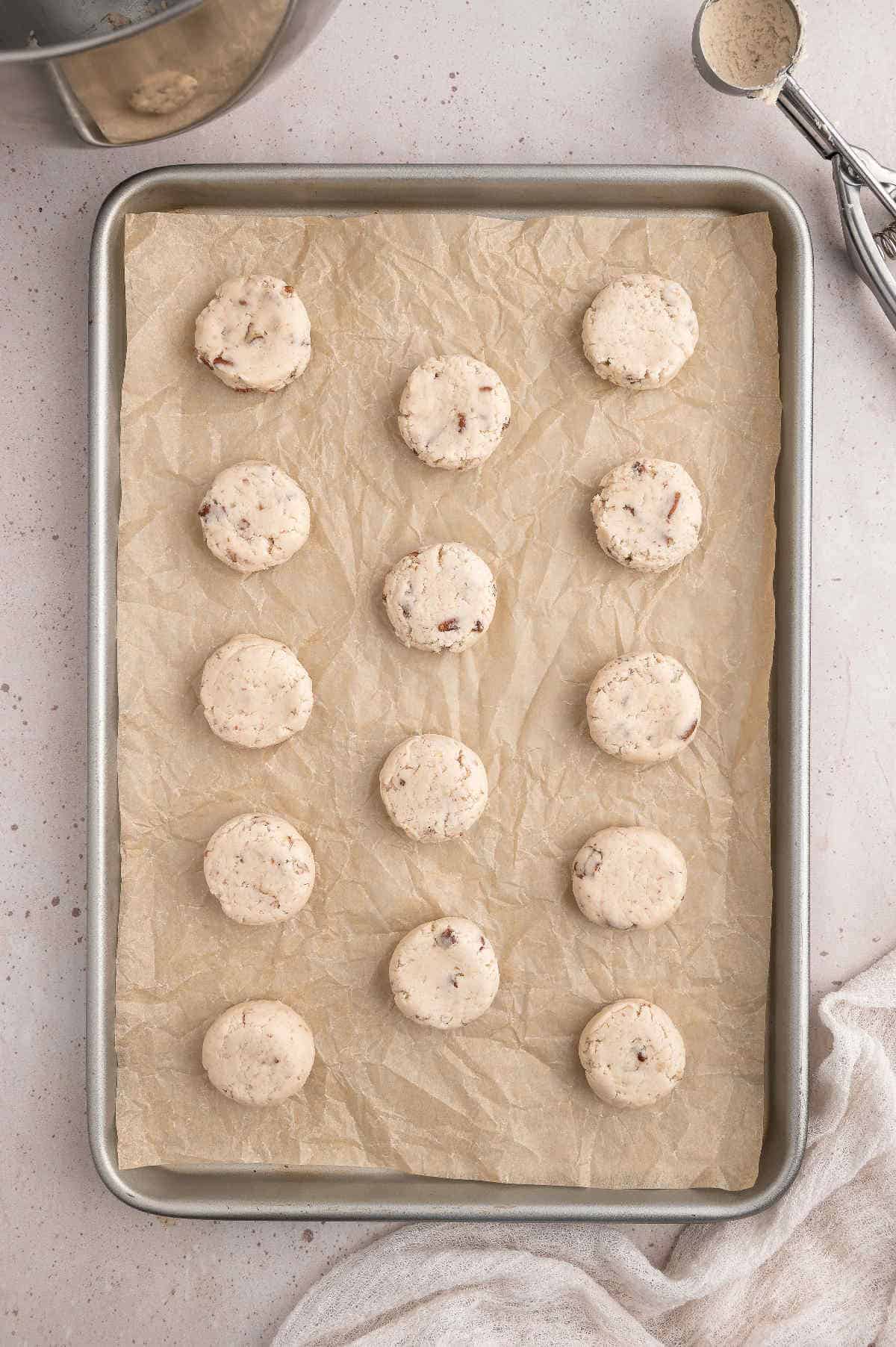 Mexican wedding cookies on a prepared baking sheet.