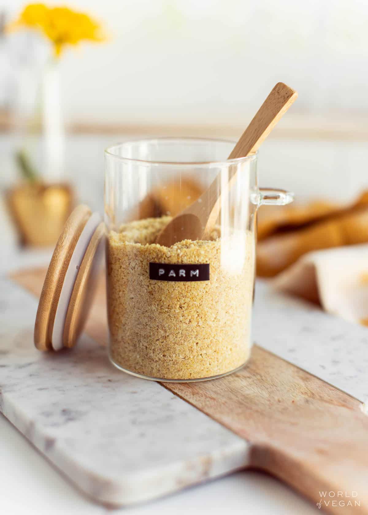 Homemade vegan parmesan cheese, stored in a glass container.