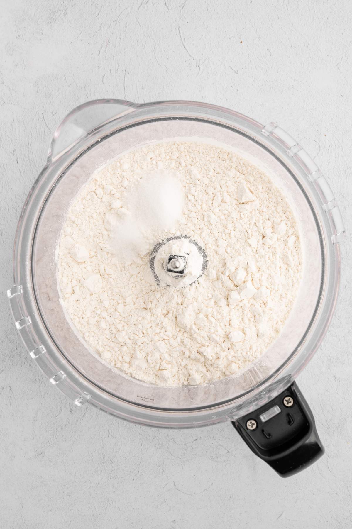 Flour, salt, and sugar in a food processor.