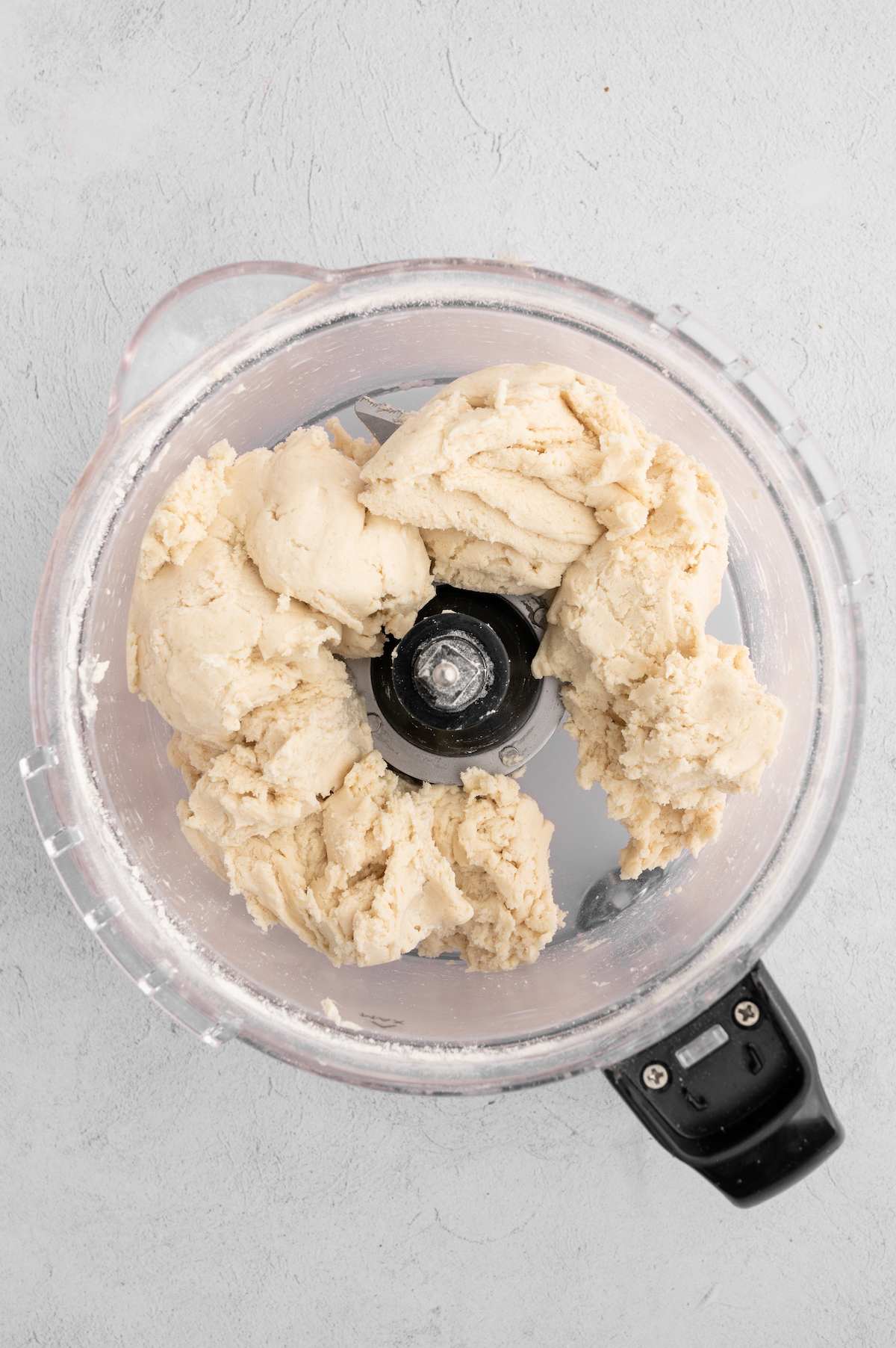 The prepared vegan pie crust dough in a food processor.