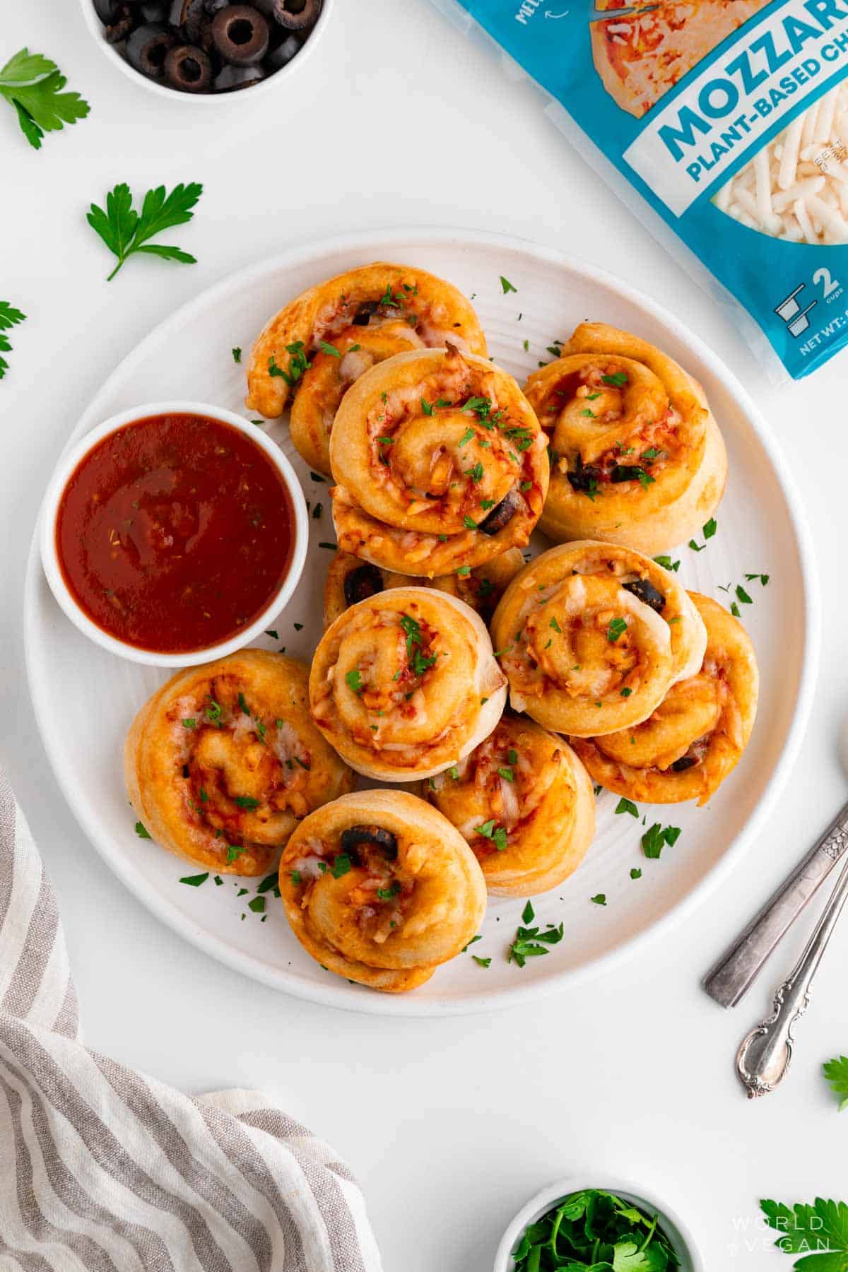 Finished pizza rolls plated with fresh herbs.