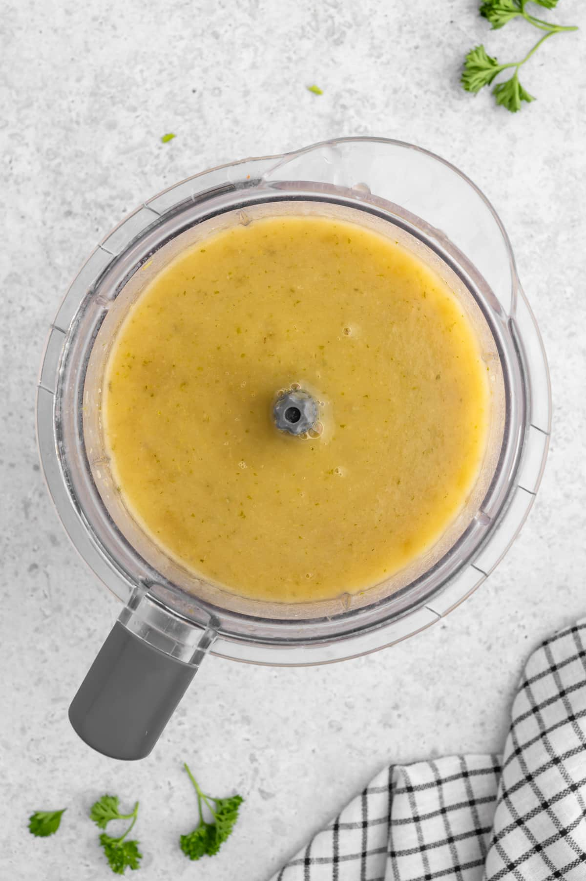 Vegan potato leek soup in a blender pitcher after blending smooth.