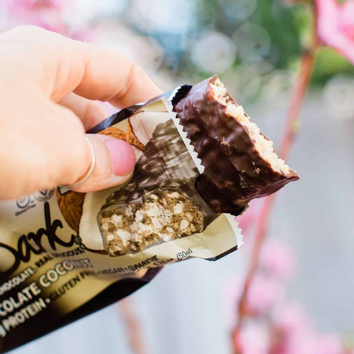 Vegan protein bar from Nugo opened showing chocolate covered inside.