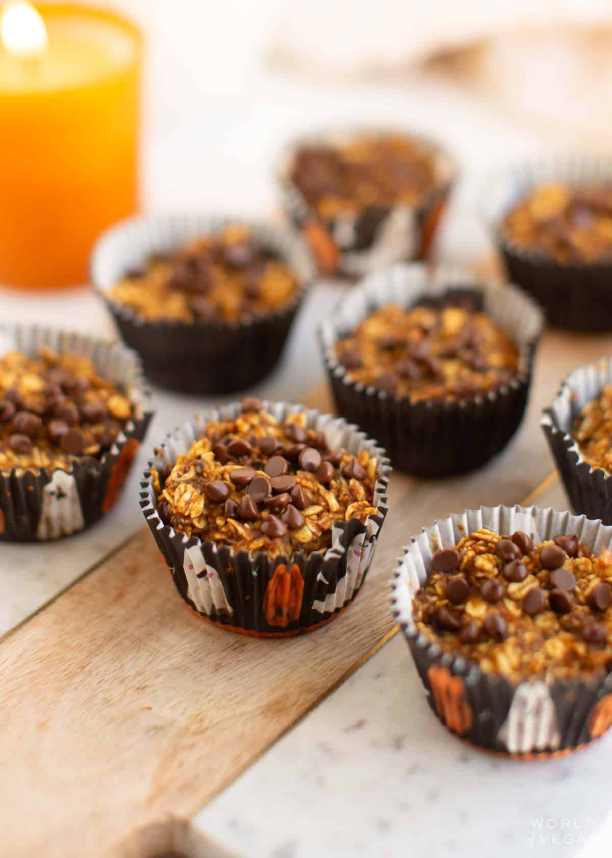 Oatmeal bites in muffin tin wrappers, sitting on a cutting board.