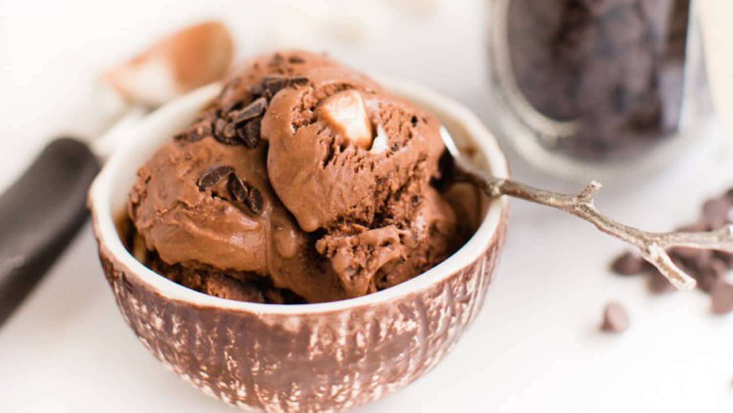 Vegan rocky road ice cream in a bowl with a spoon.