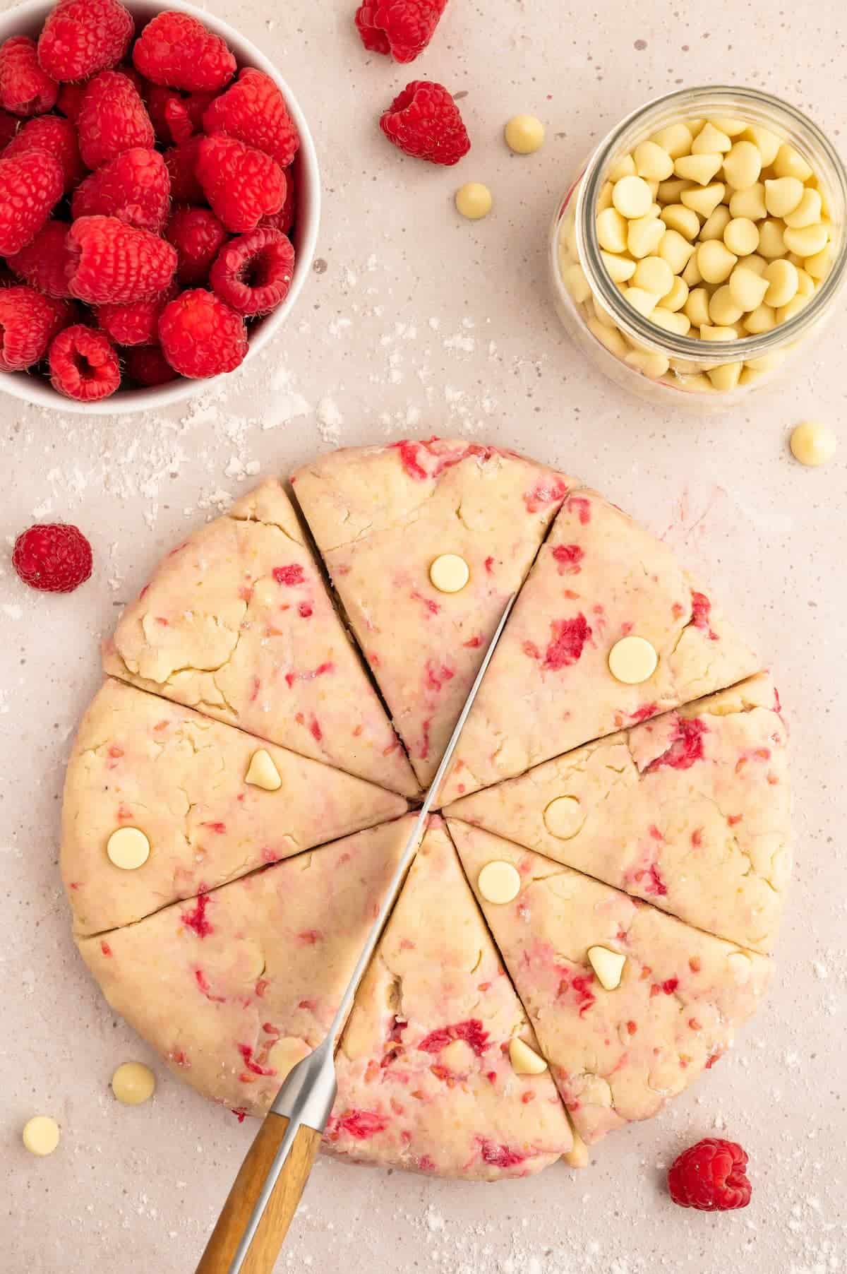 Vegan scone dough, cut into eight pieces.