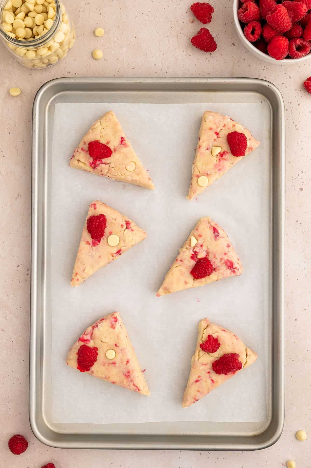 Vegan scone done, cut and laid out on a baking sheet.