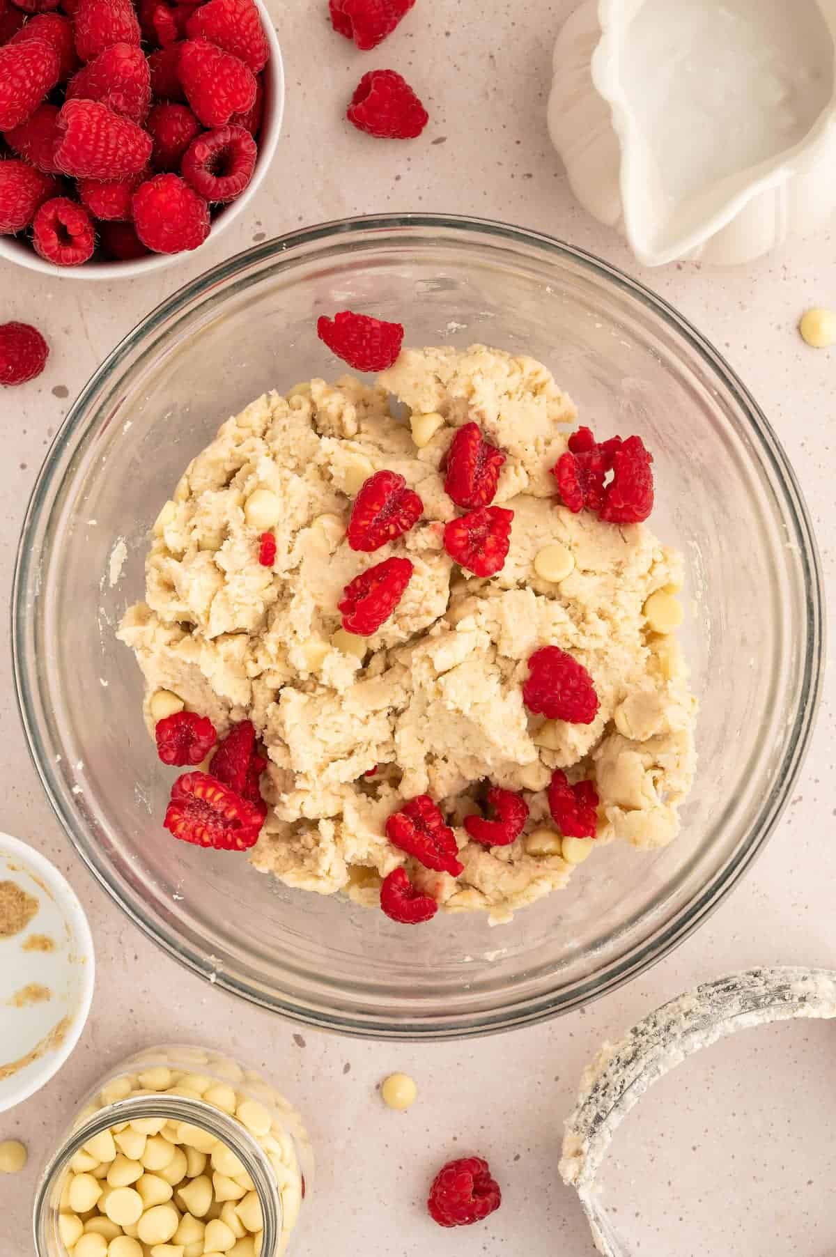 Vegan scone dough, with raspberries on top.