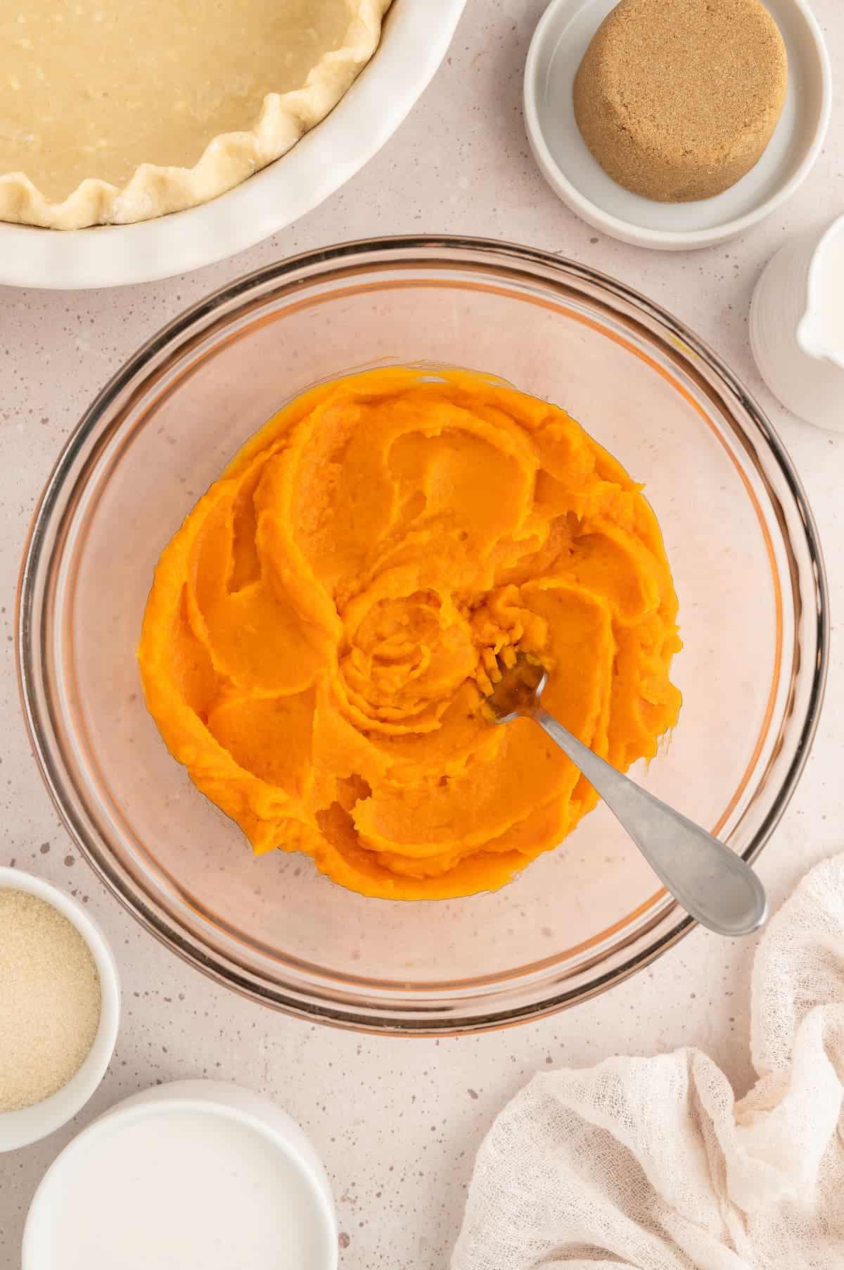 Sweet potatoes that have been mashed into a puree in a bowl.