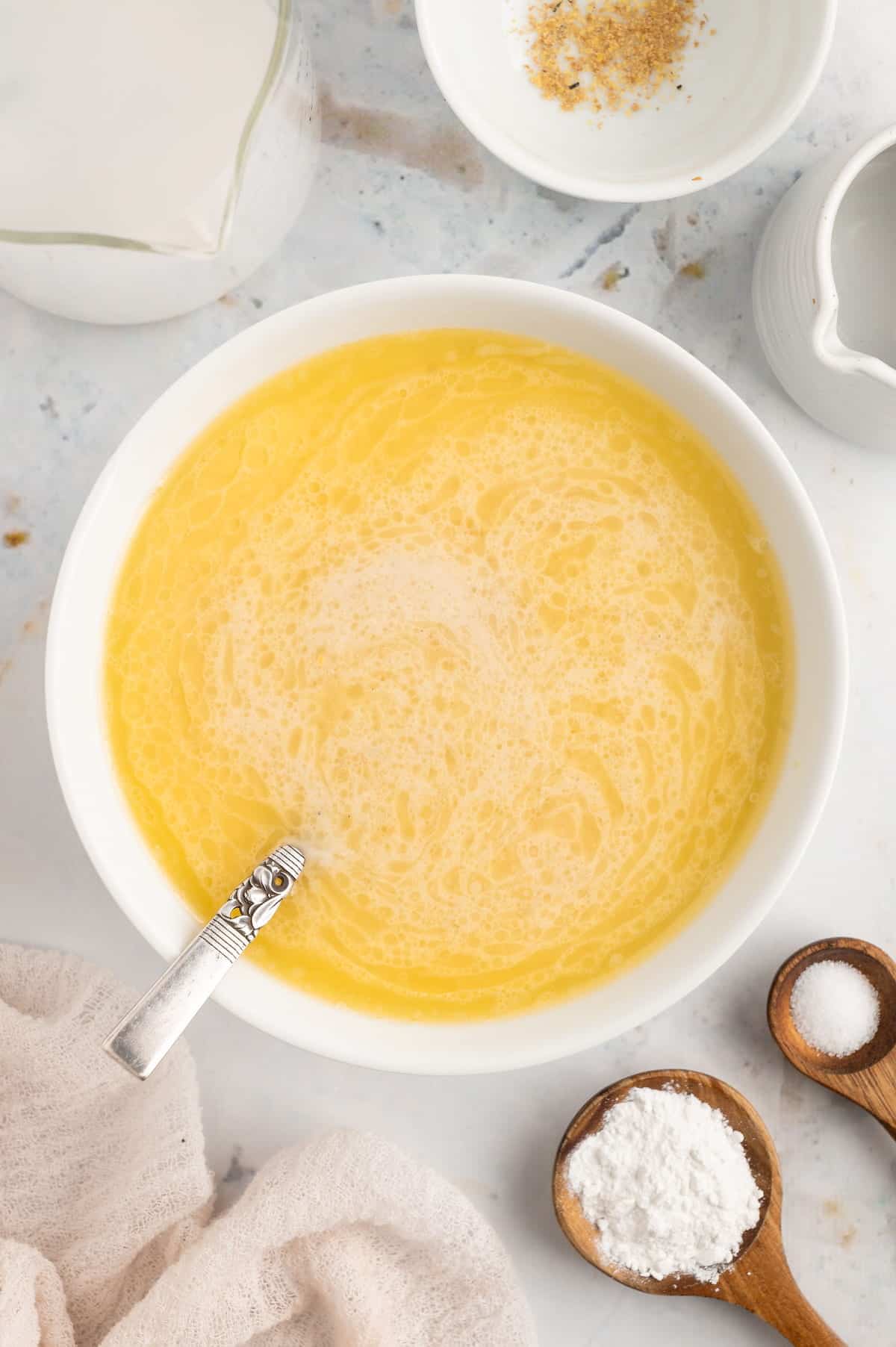 A top-down shot of vegan butter and vegan milk in a bowl.