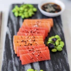 Vegan Zeastar Salmon Sashimi on a plate with edamame and sesame seeds