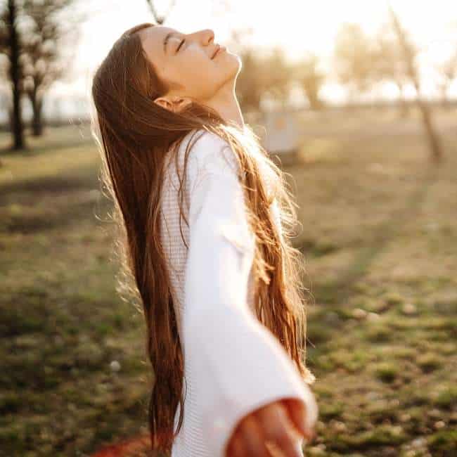 girl standing in sun to get vitamin d