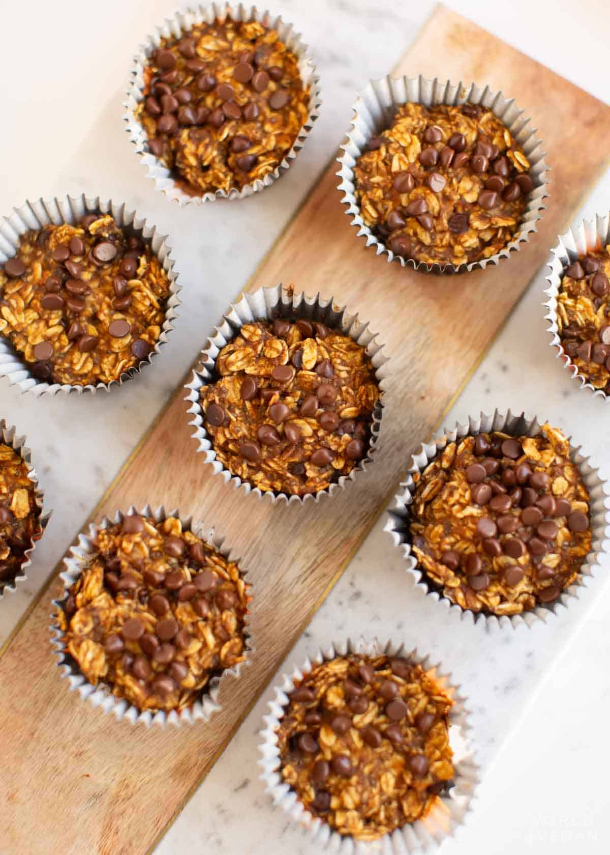 Baked oatmeal bites sitting on a cutting board.