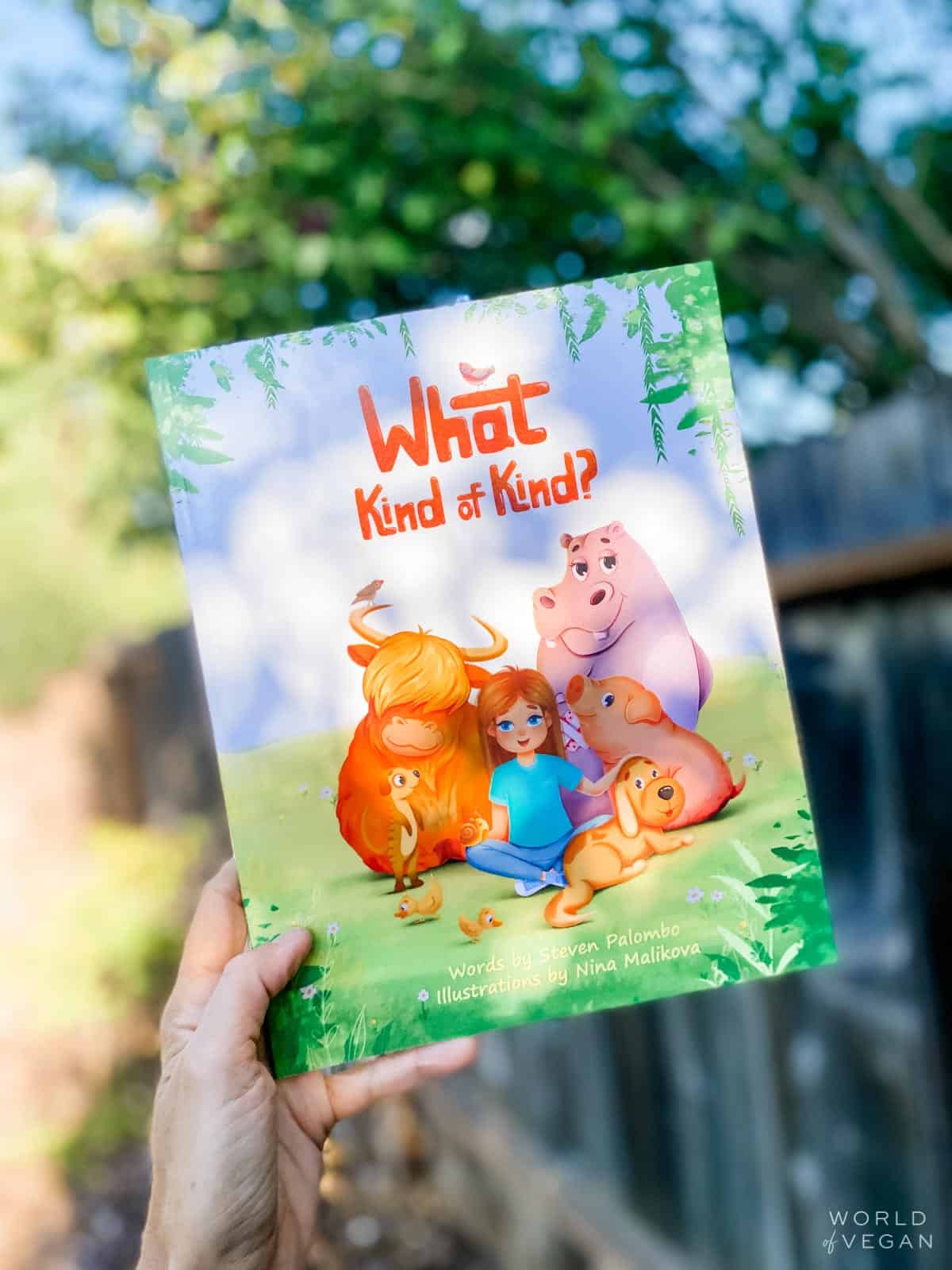 holding out cover of what kind of kind vegan kids book