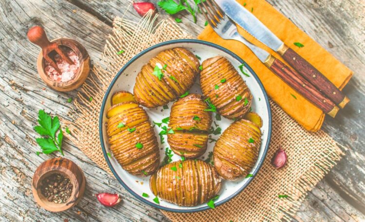 Vegan Hasselback Potatoes served on a table