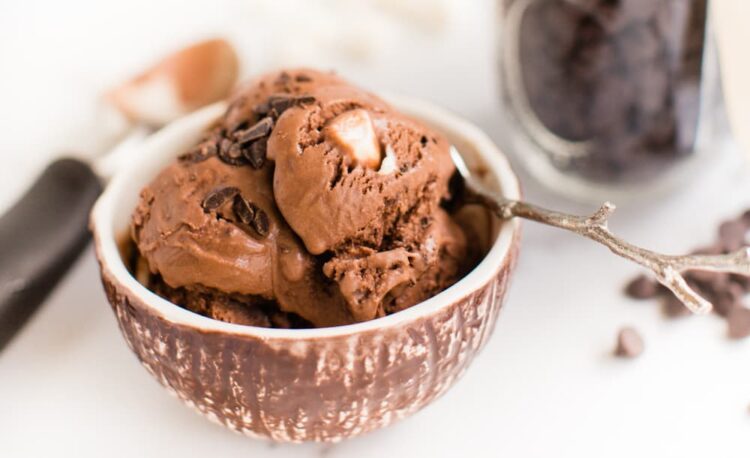 Vegan Rocky Road Ice Cream scooped into a bowl with dairy free chocolate and vegan marshmallows.