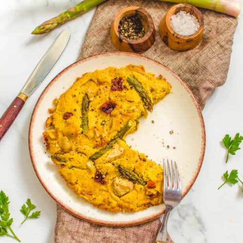 Rustic plate with a tofu based vegan frittata with asparagus and veggies.