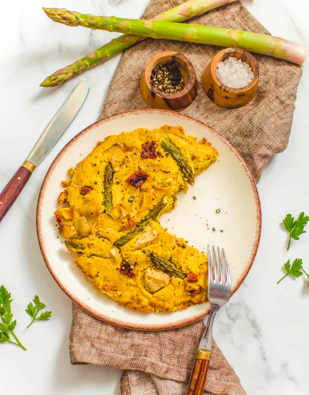 Rustic plate with a tofu based vegan frittata with asparagus and veggies. 