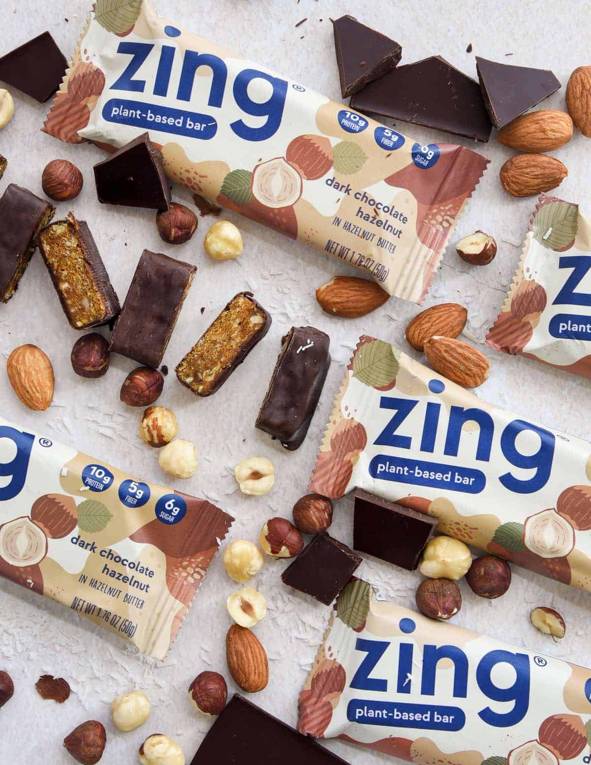 Zing Bars on a table with nuts and plant-based ingredients. 